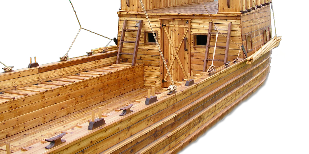 large wooden boat with an awning and bench lockers