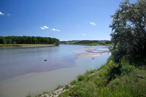 Small, muddy river enters the blue Missouri